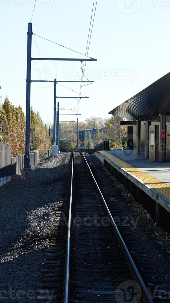 The railway view with the track and the colorful woods as background in the autumn morning photo