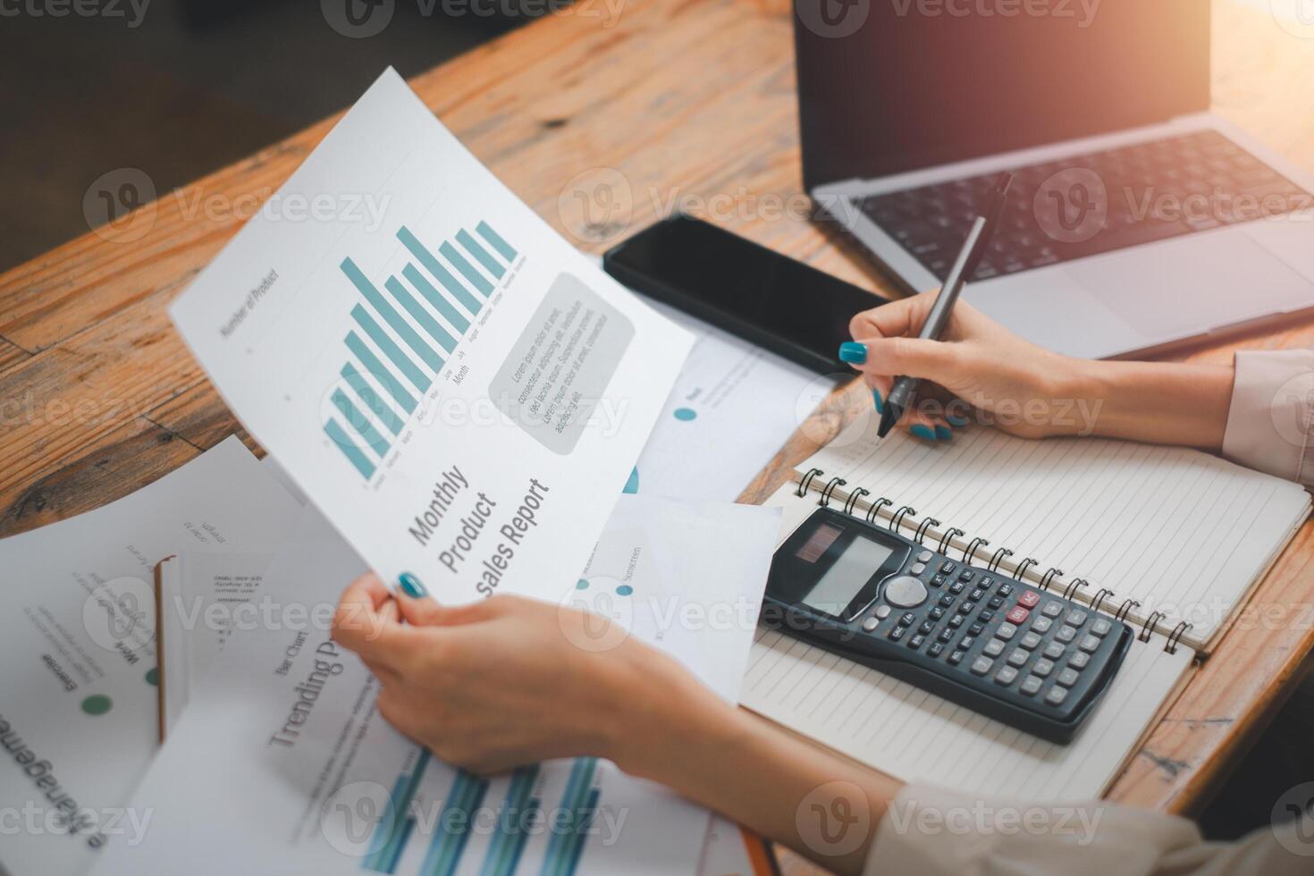 Business woman analysis summary graph reports of business operating expenses and work data about the company's financial statements. photo