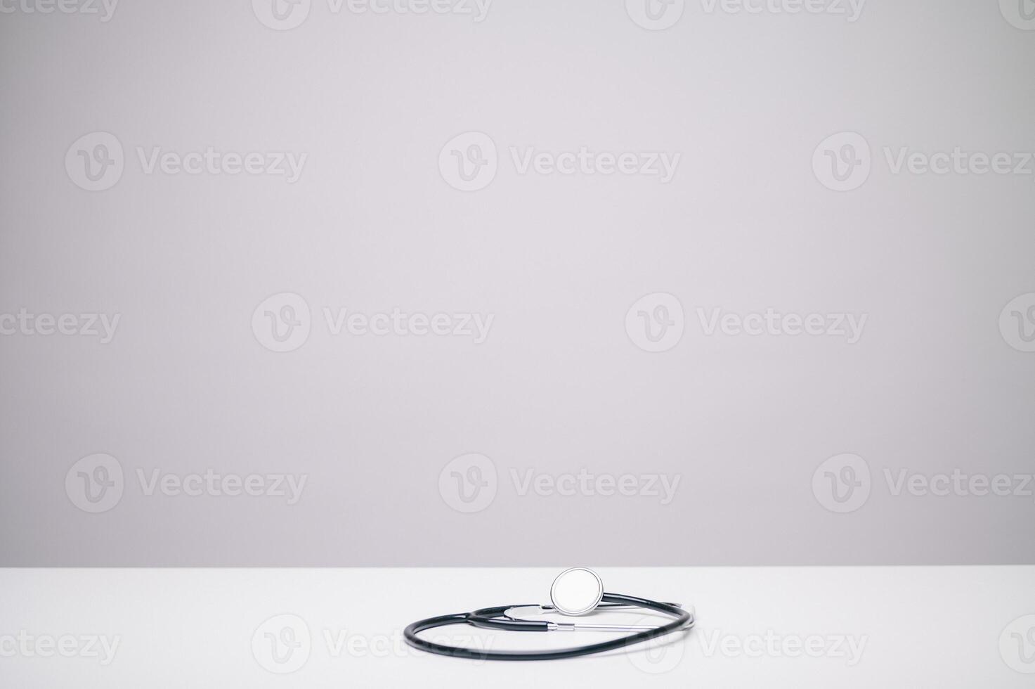 The stethoscope, against a white background, symbolizes the essence of healthcare, a universal emblem representing the commitment to medical care and well-being. photo