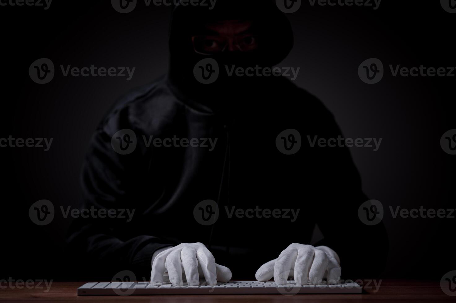 Hacker, security concept. Hacker, typing intricate code on a laptop, establishes an online connection, aiming to breach server security, hack passwords, and gain unauthorized access to the database photo