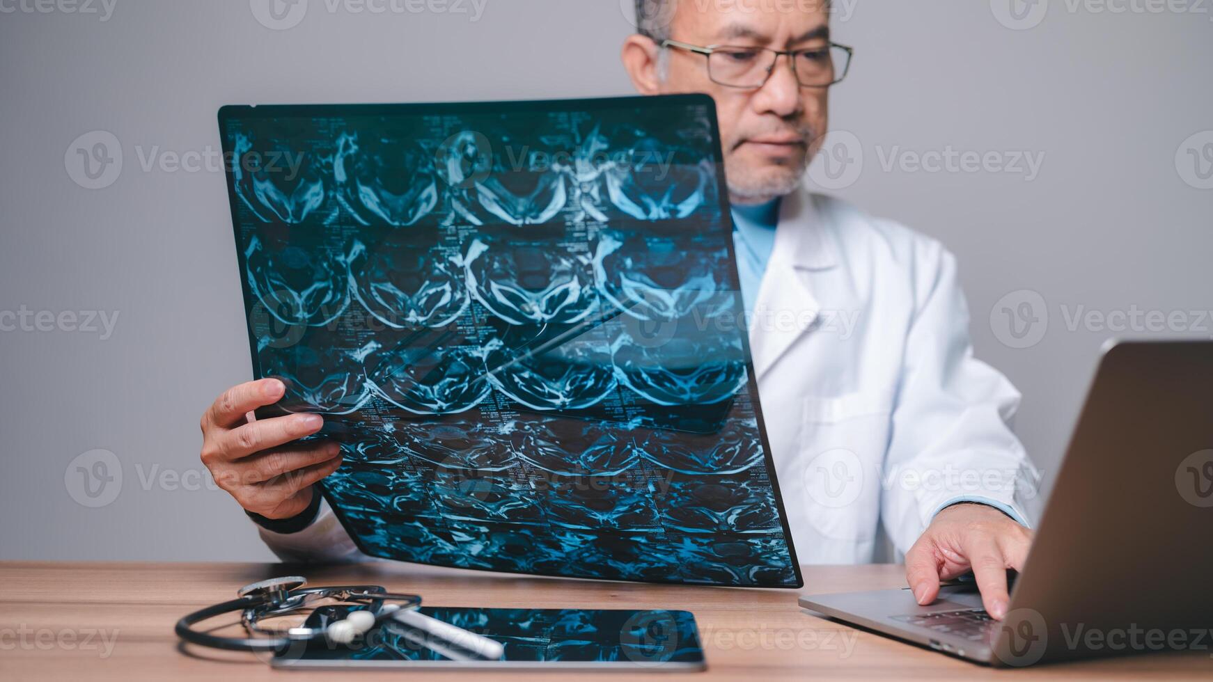 Doctor, lab concept. Professional doctor, holding and scrutinizing an X-ray film, works diligently in hospital laboratory, ensuring precise examination and accurate diagnosis in field of medicine photo