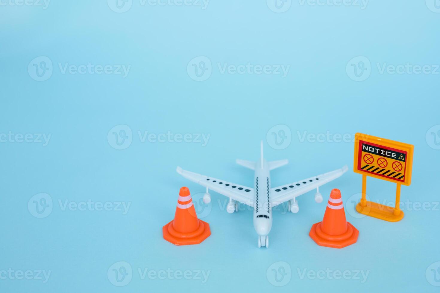 White airplane model with prohibition sign on blue background photo