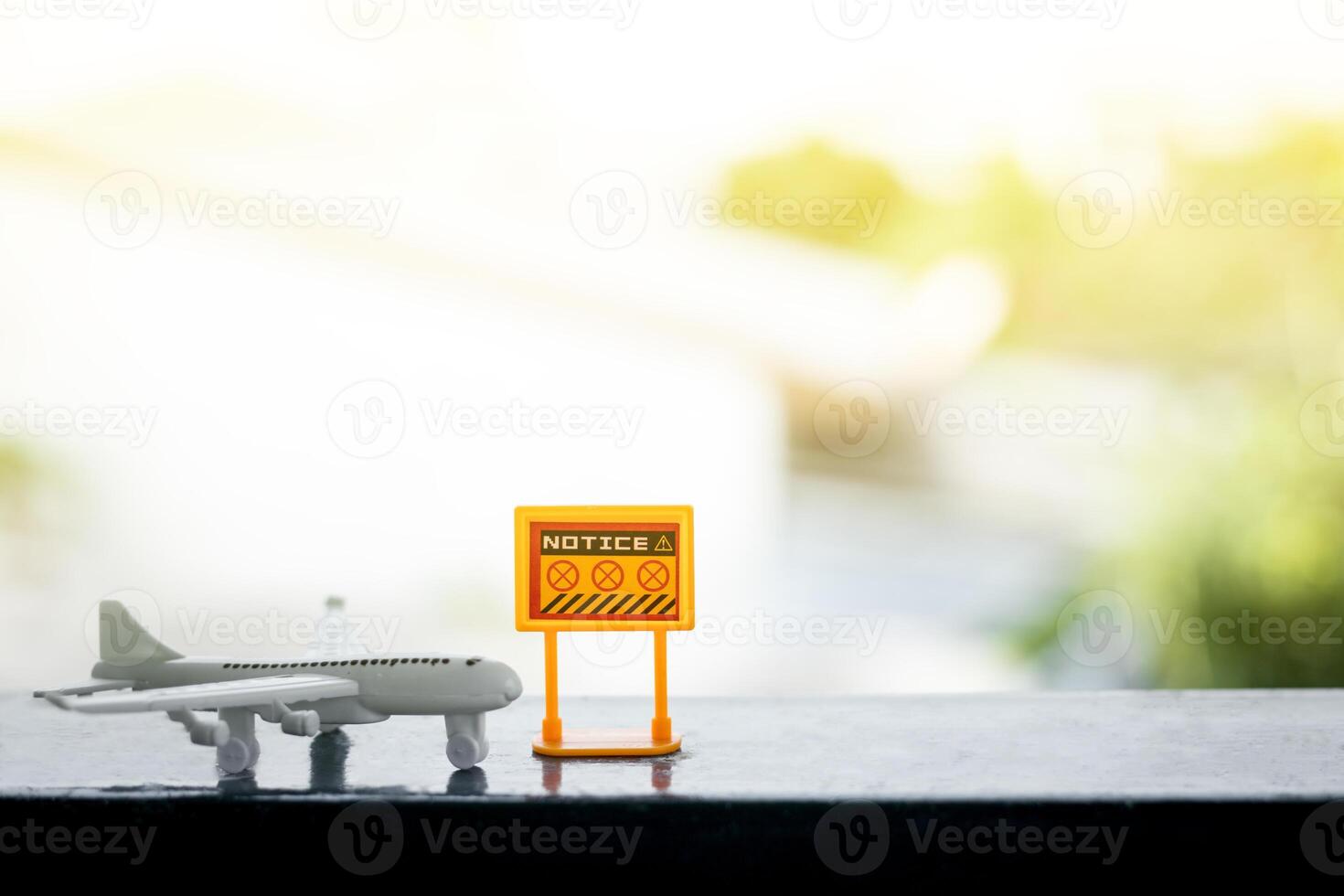 White airplane model with prohibition sign on blurred outdoor background photo