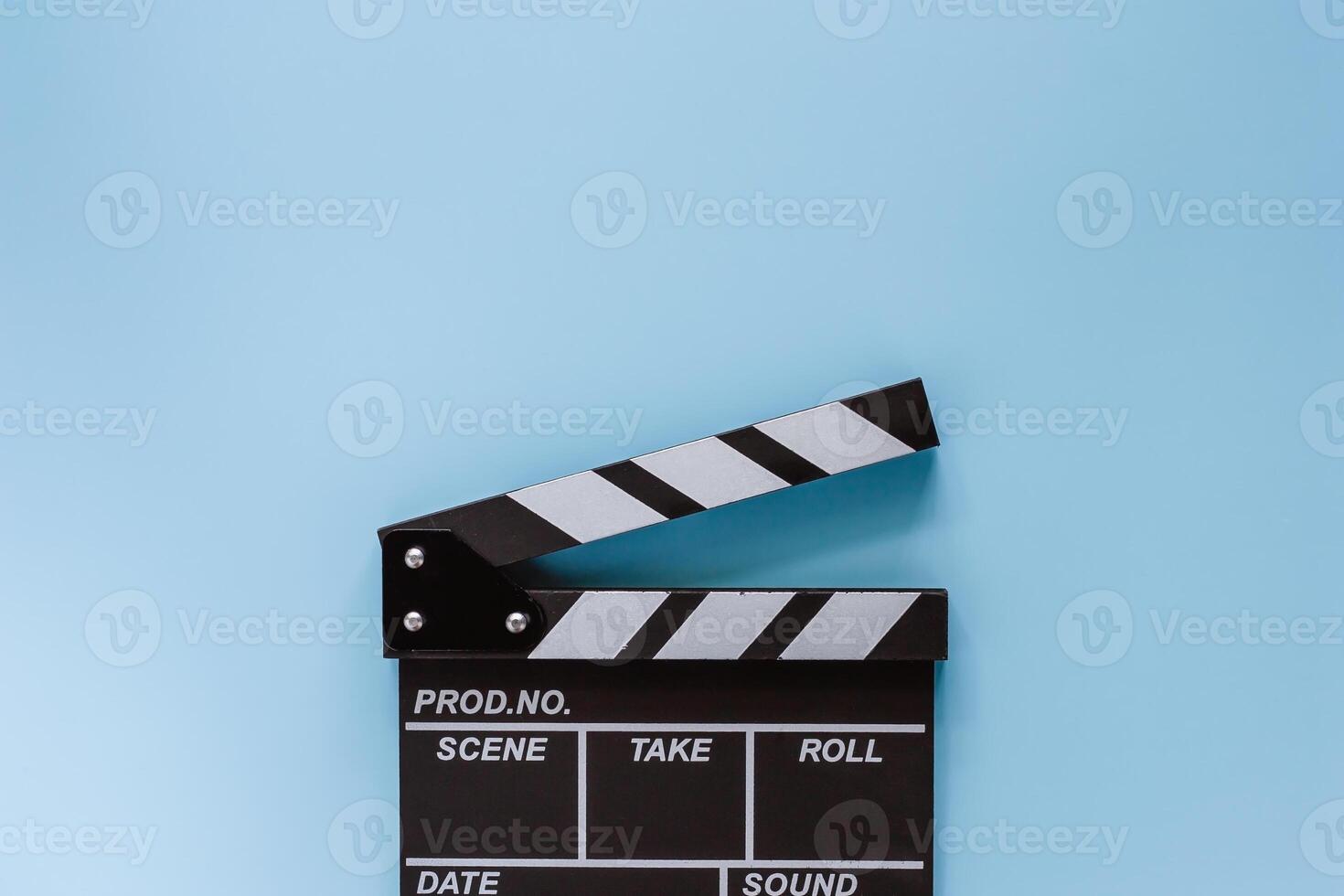 Movie clapper board on blue background photo