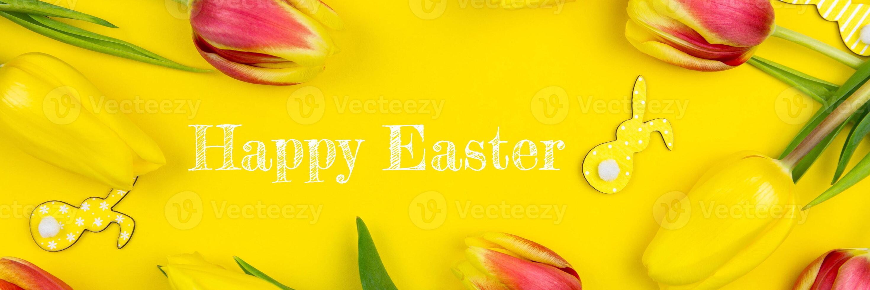 Happy easter floral banner flat lay with various bunnies and colorful tulips on yellow background. Top view. Copy space. photo
