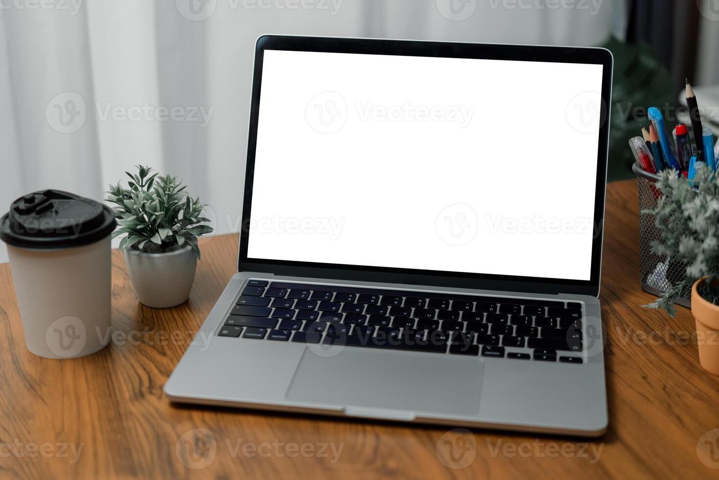 Mock up laptop computer white screen on desk photo