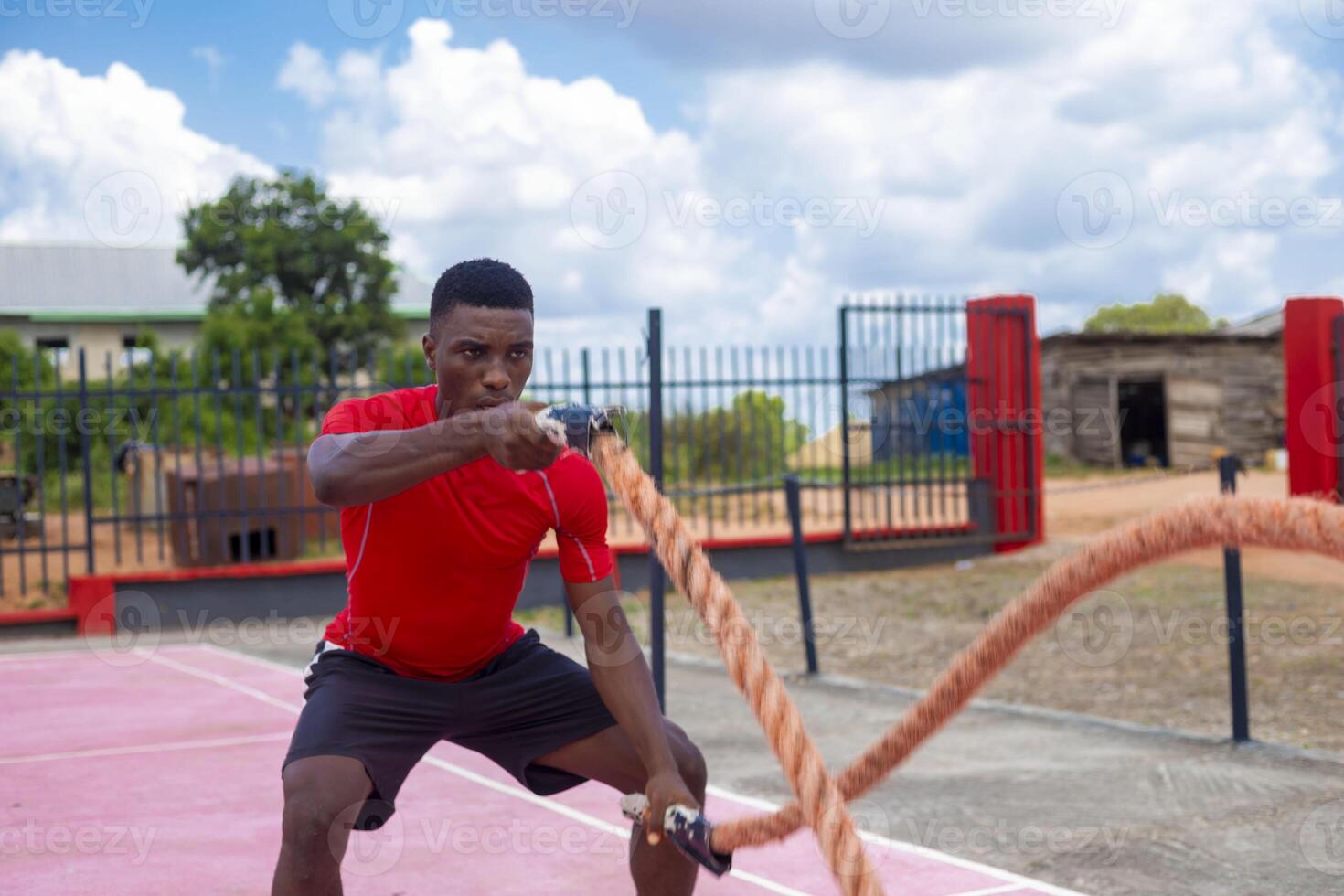 Men with battle rope battle ropes exercise in the fitness gym. photo