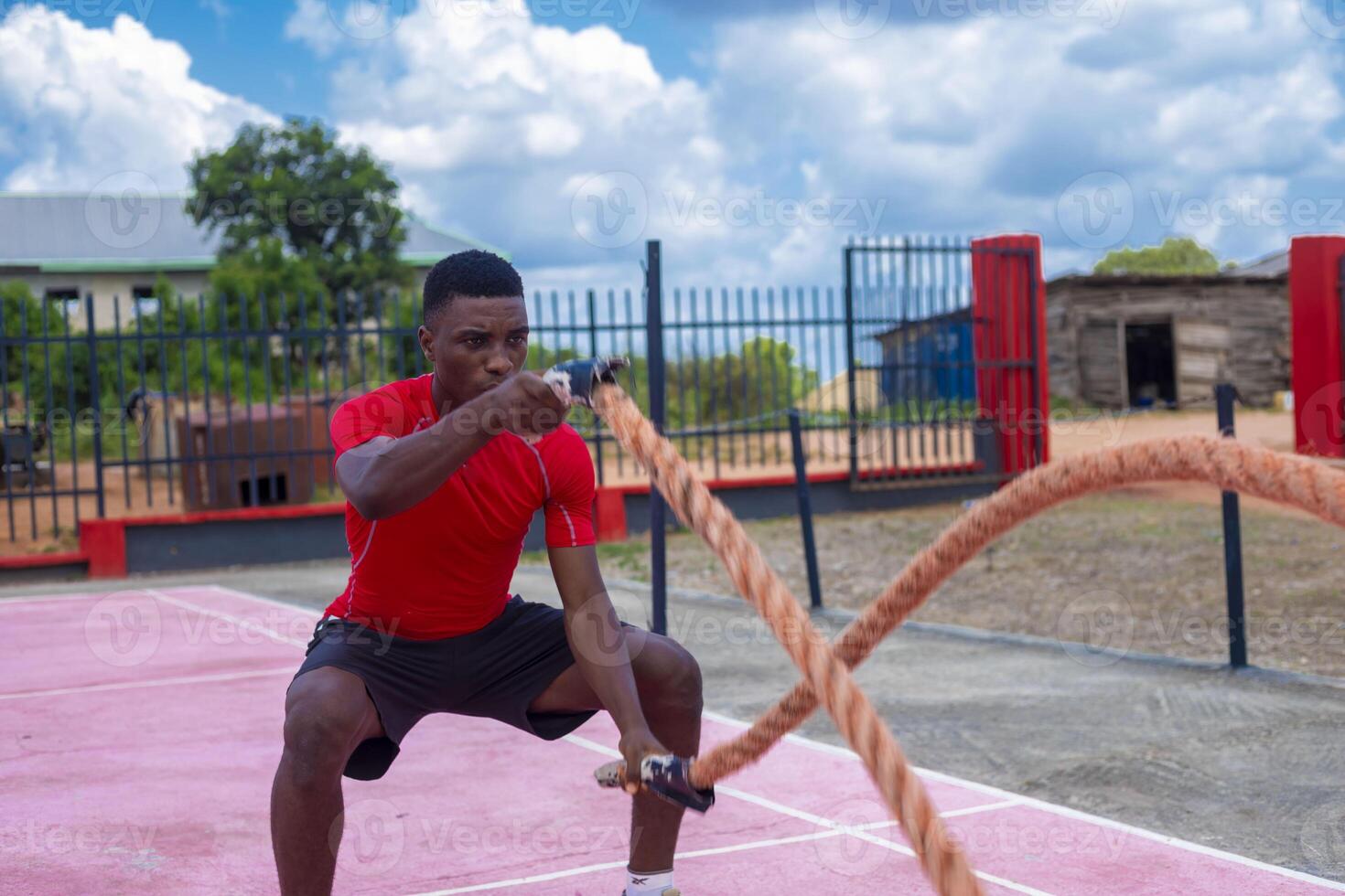 Men with battle rope battle ropes exercise in the fitness gym. photo