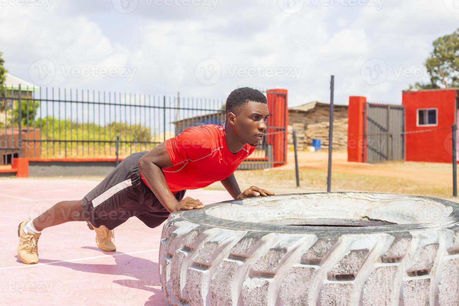 Concept lifting, workout training. A guy lifts a tire on the gym floor photo