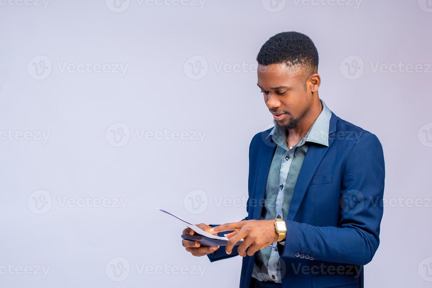 handsome accountant using calculator to calculate his budget photo