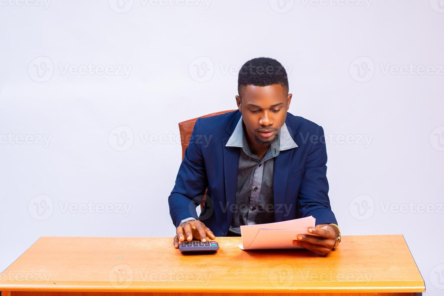 handsome african accountant in the office going the calculation on his invoice photo