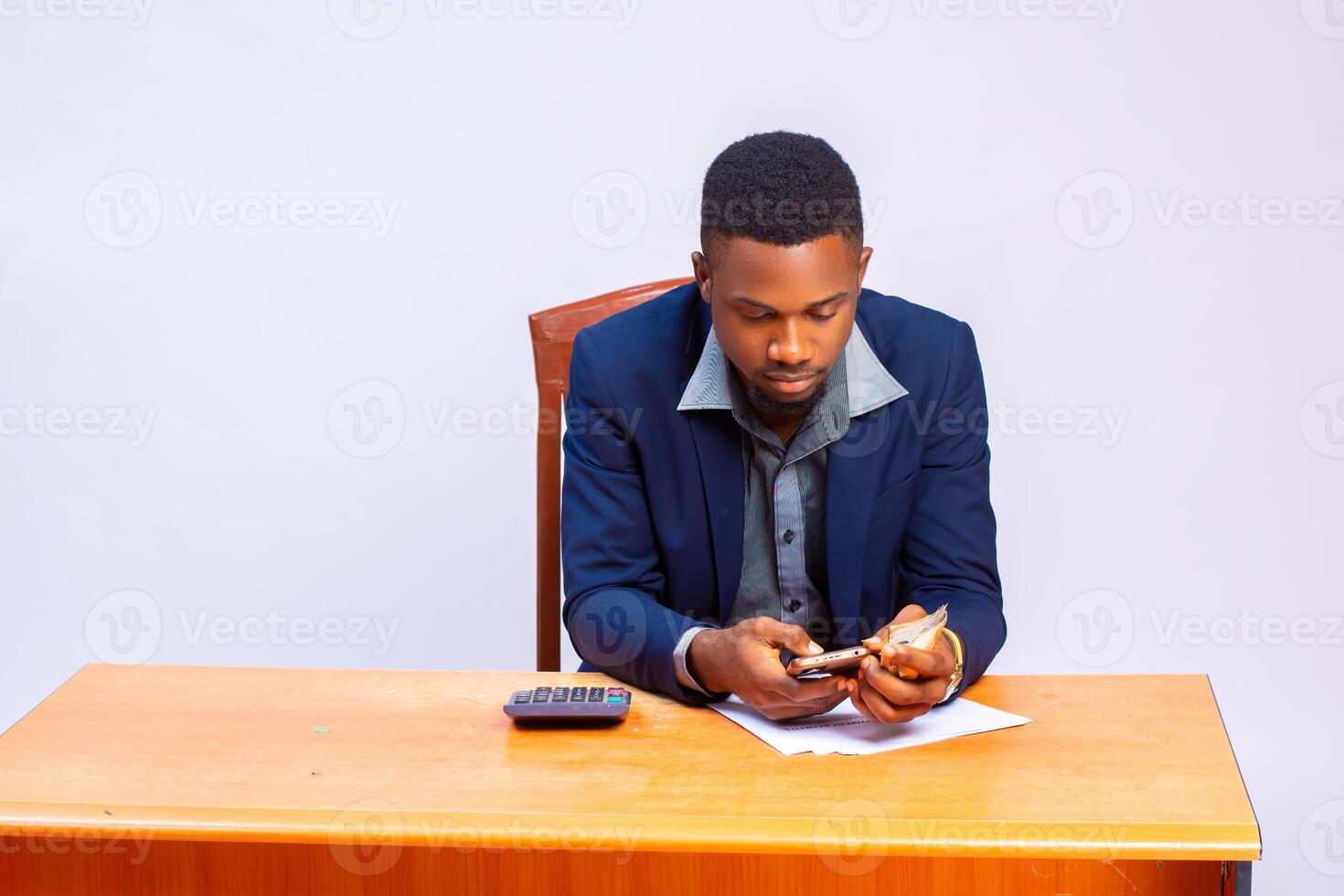 handsome african business using calculator to calculate his expense photo