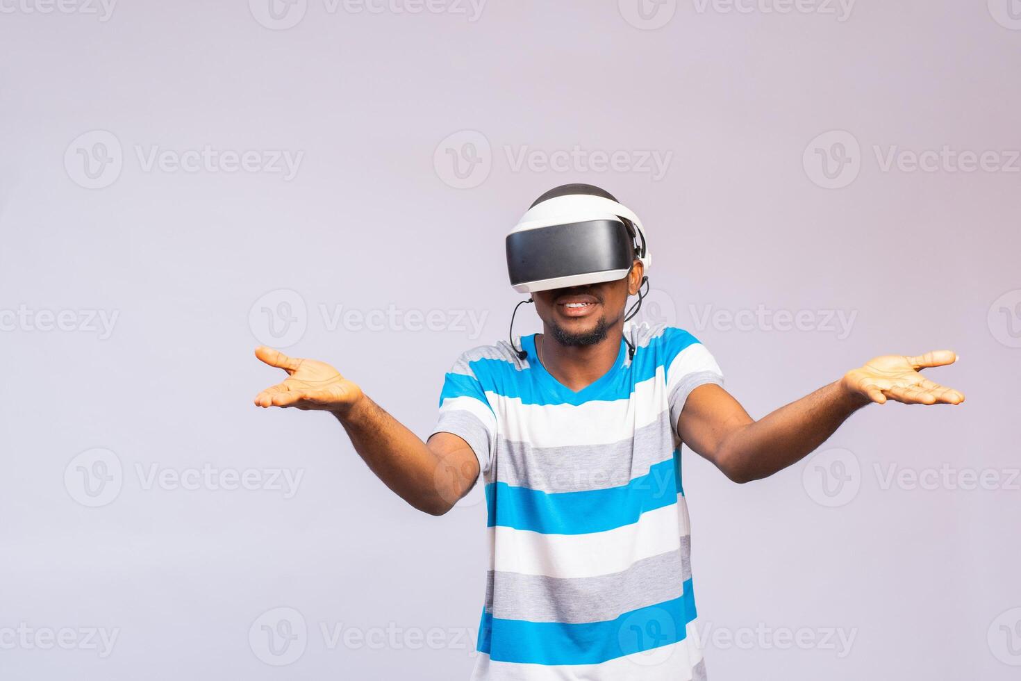 Young african american man playing virtual reality game using goggles photo