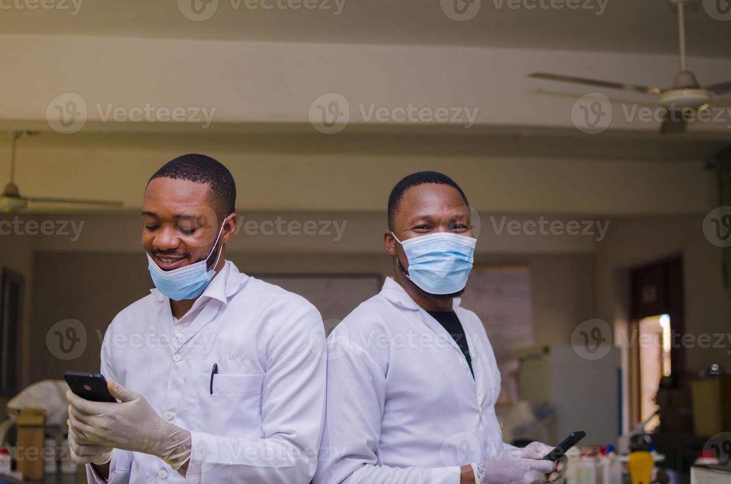 overexcited two african doctors operating their phone photo