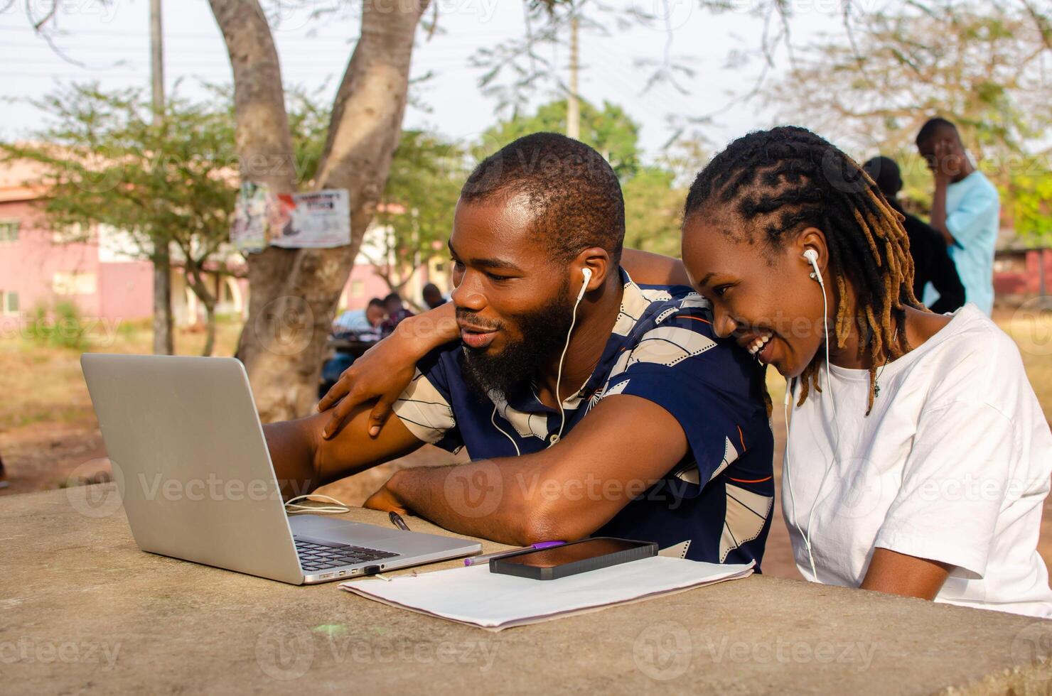 overexcited youths smiling at what they saw on their laptop photo