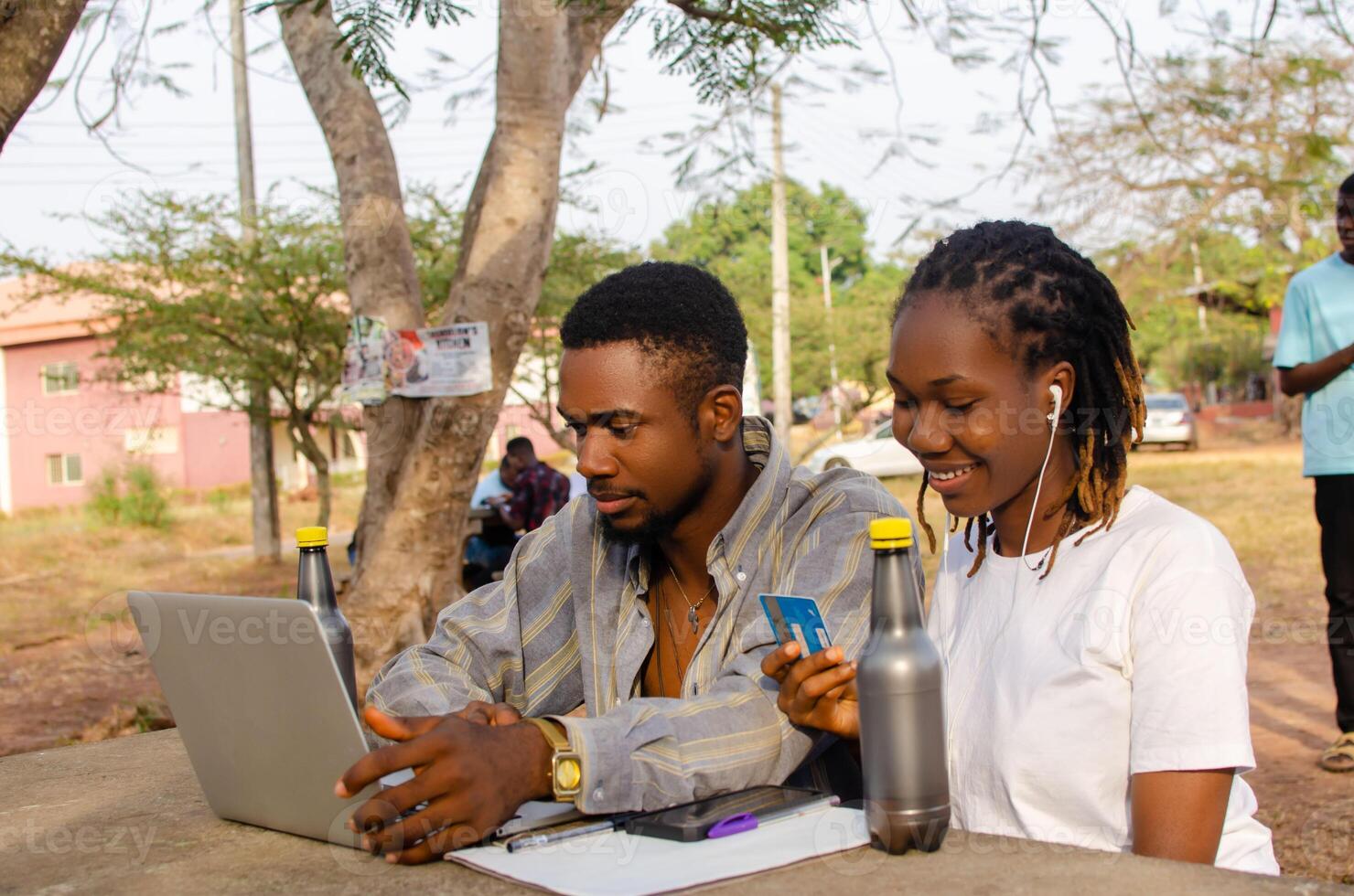 Cheerful man and woman watching video on laptop smiling and laughing photo