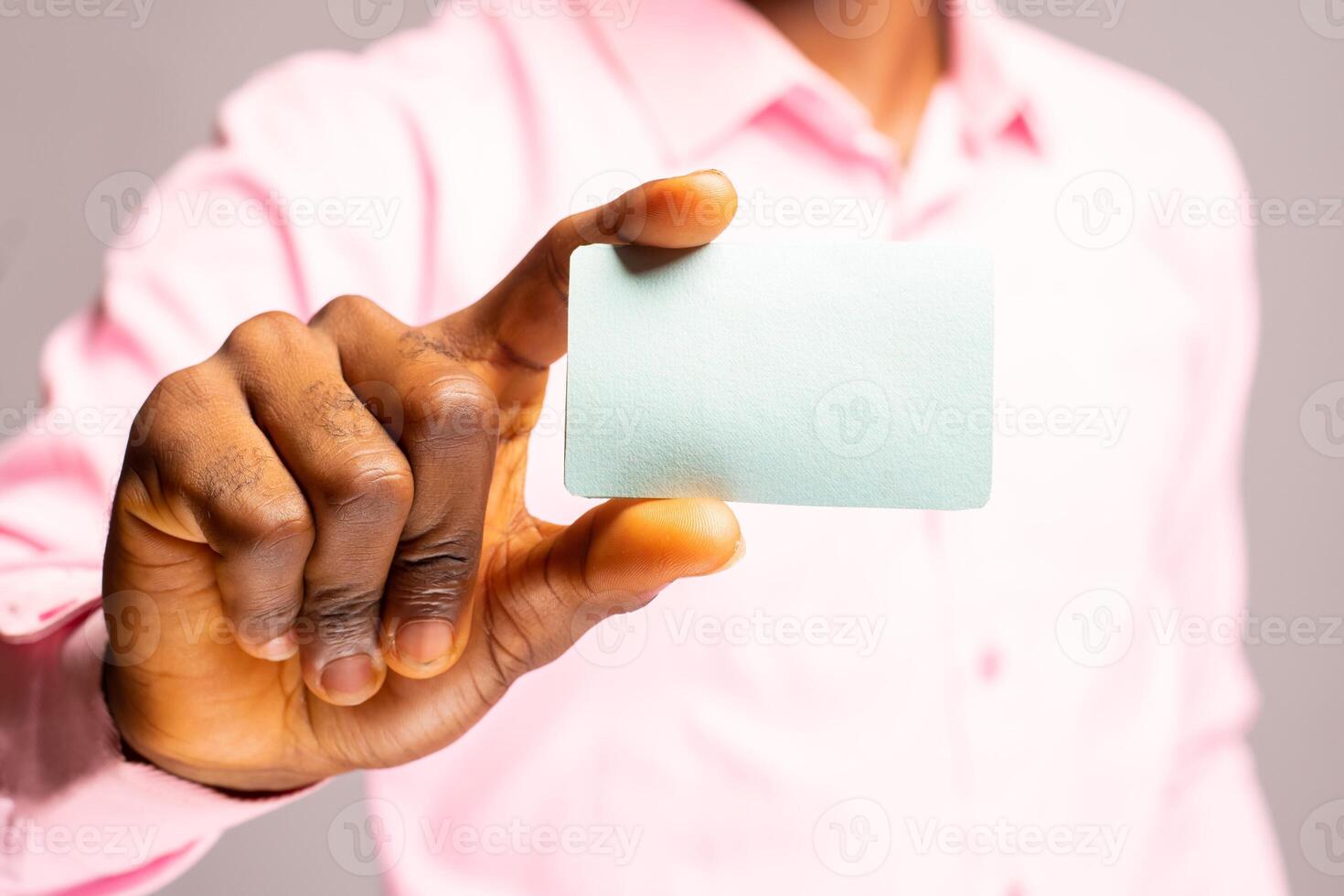 close up of a man holding his voters card photo