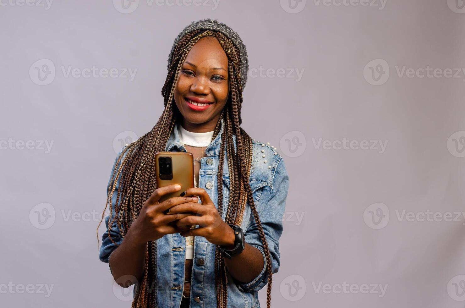 excited lady smiling as she operates her cellphone photo