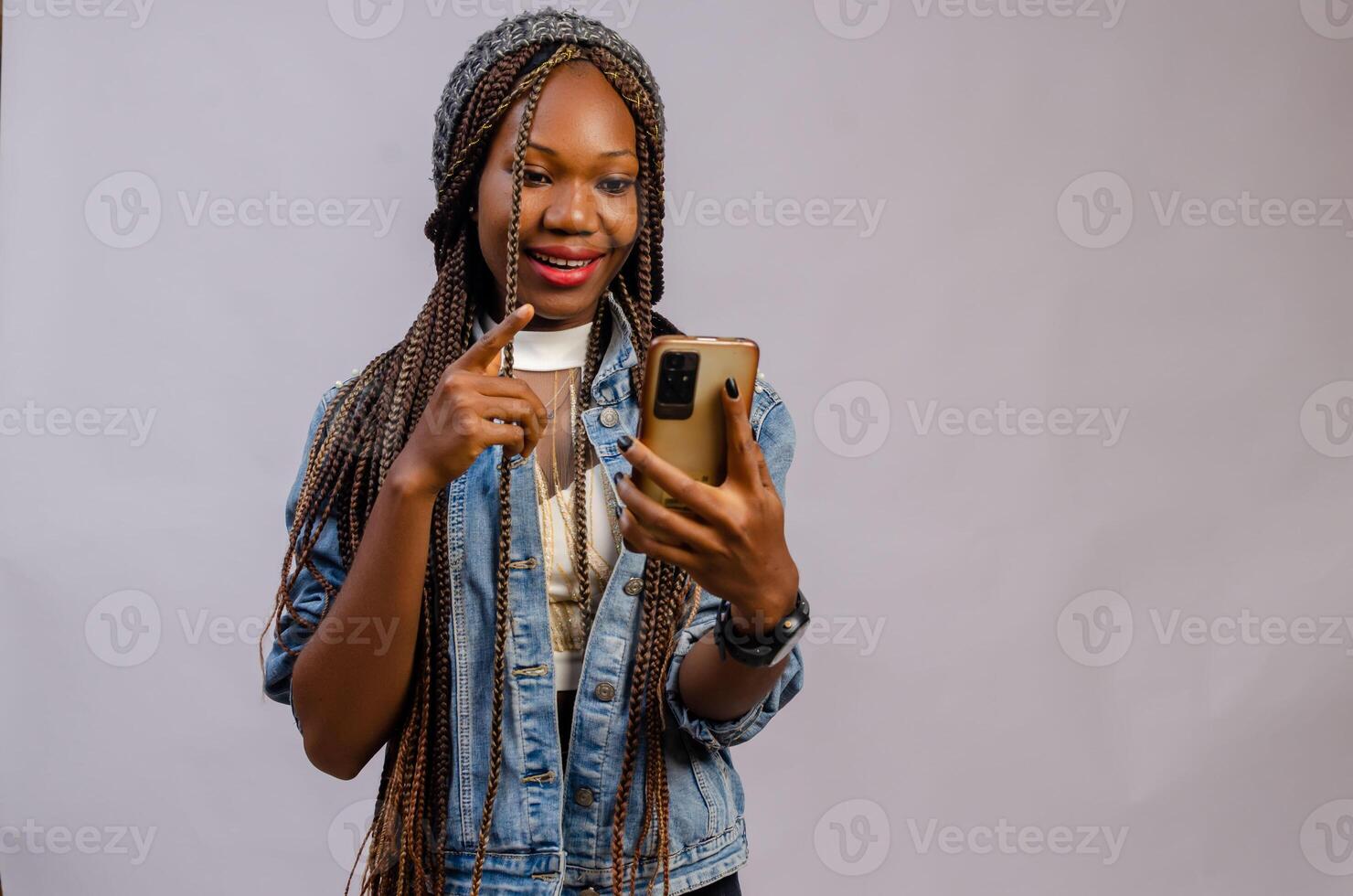 lady isolated over white background pointing to her phone photo