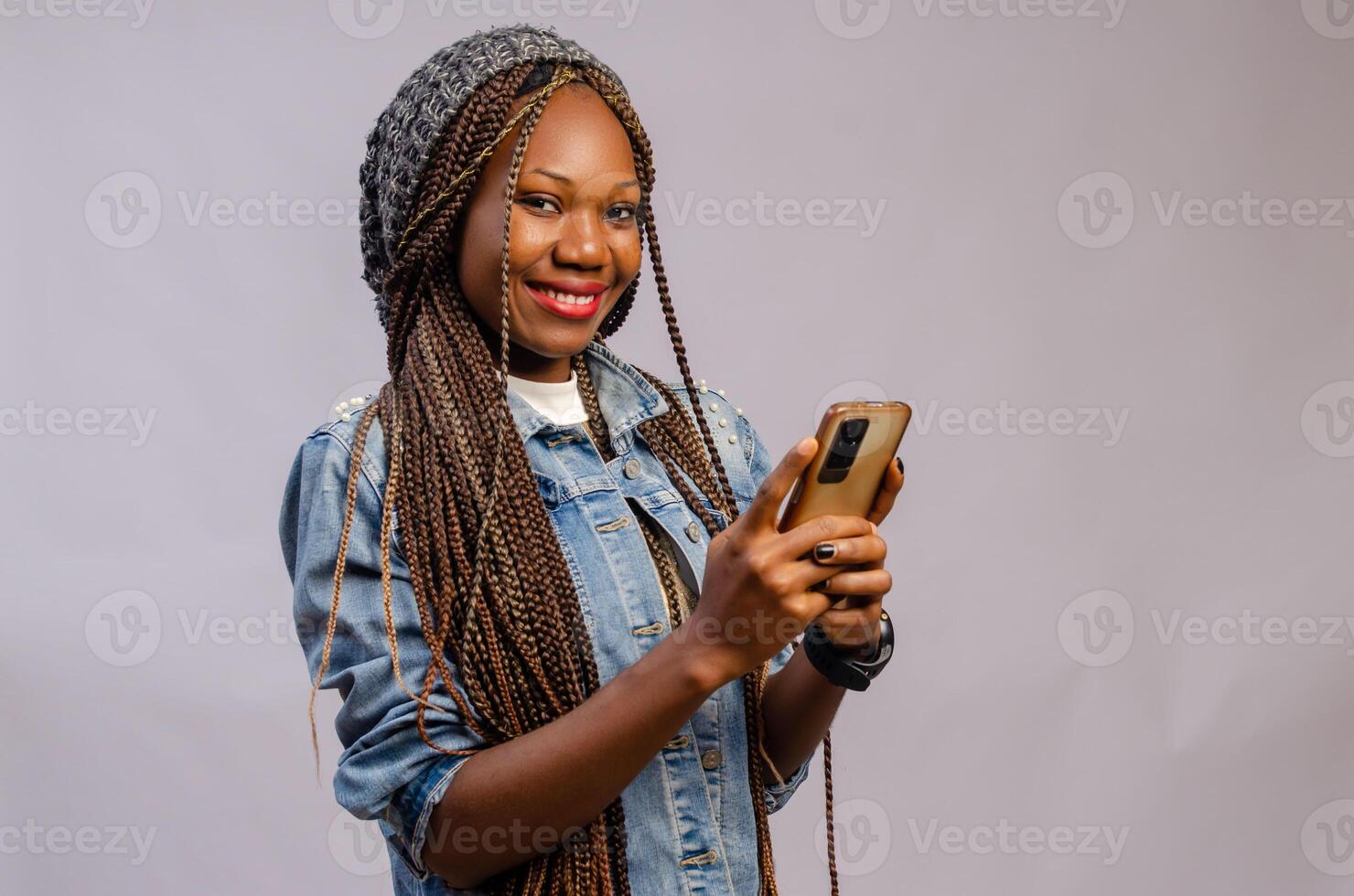 excited pretty lady smiling as she operates her cellphone photo