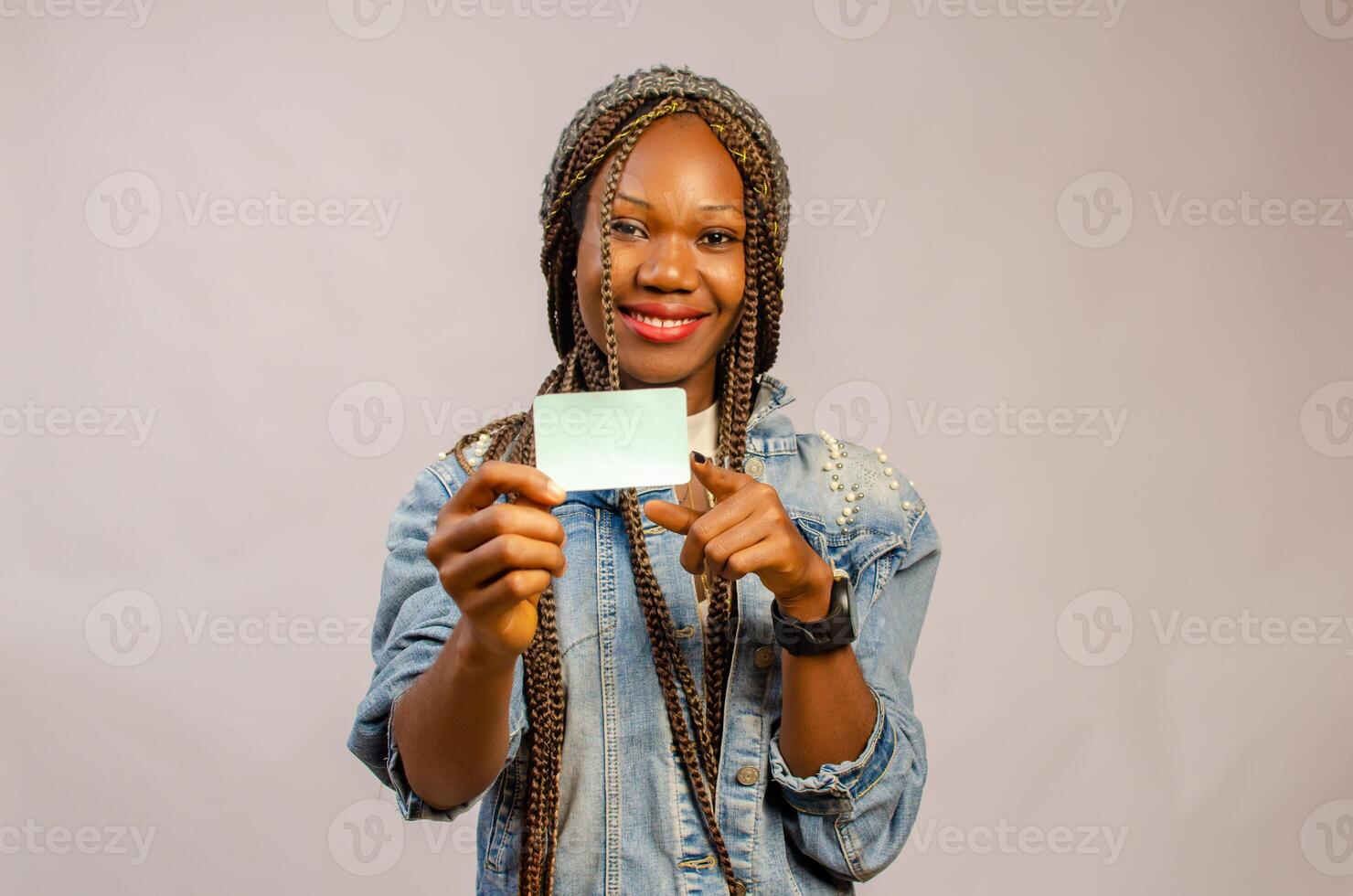 beautiful lady holding and pointing to the card on her hand photo