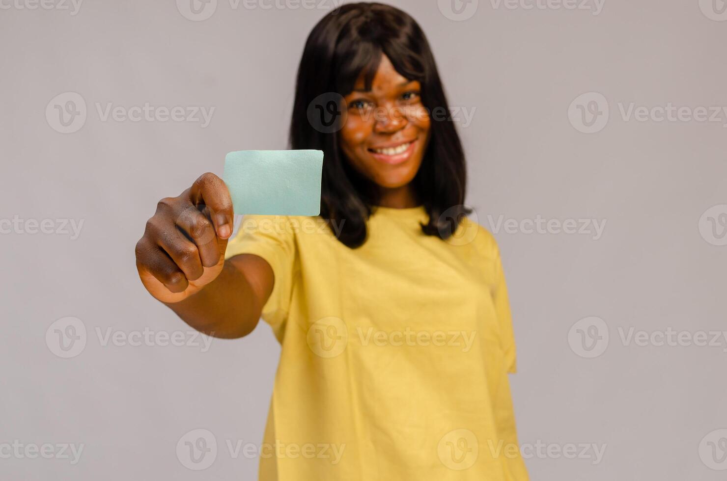 Smiling business woman hold white credit card. Isolated portrait. photo