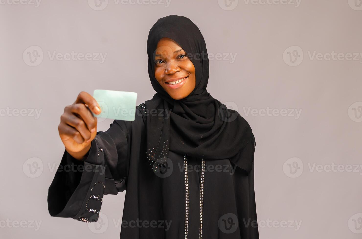 Muslim young woman with business card in hand photo