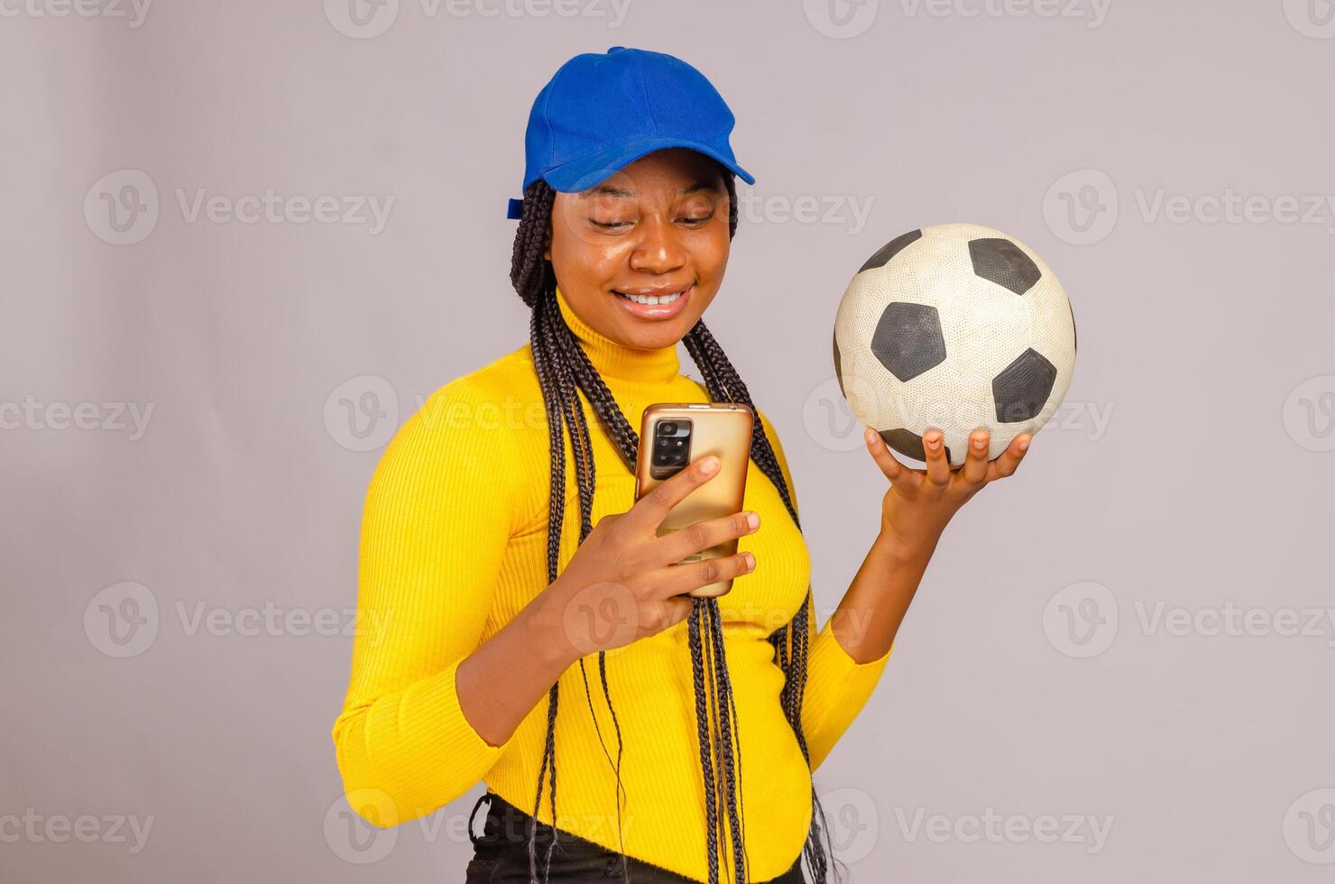 Young beautiful lady making sport bets online using mobile application. photo