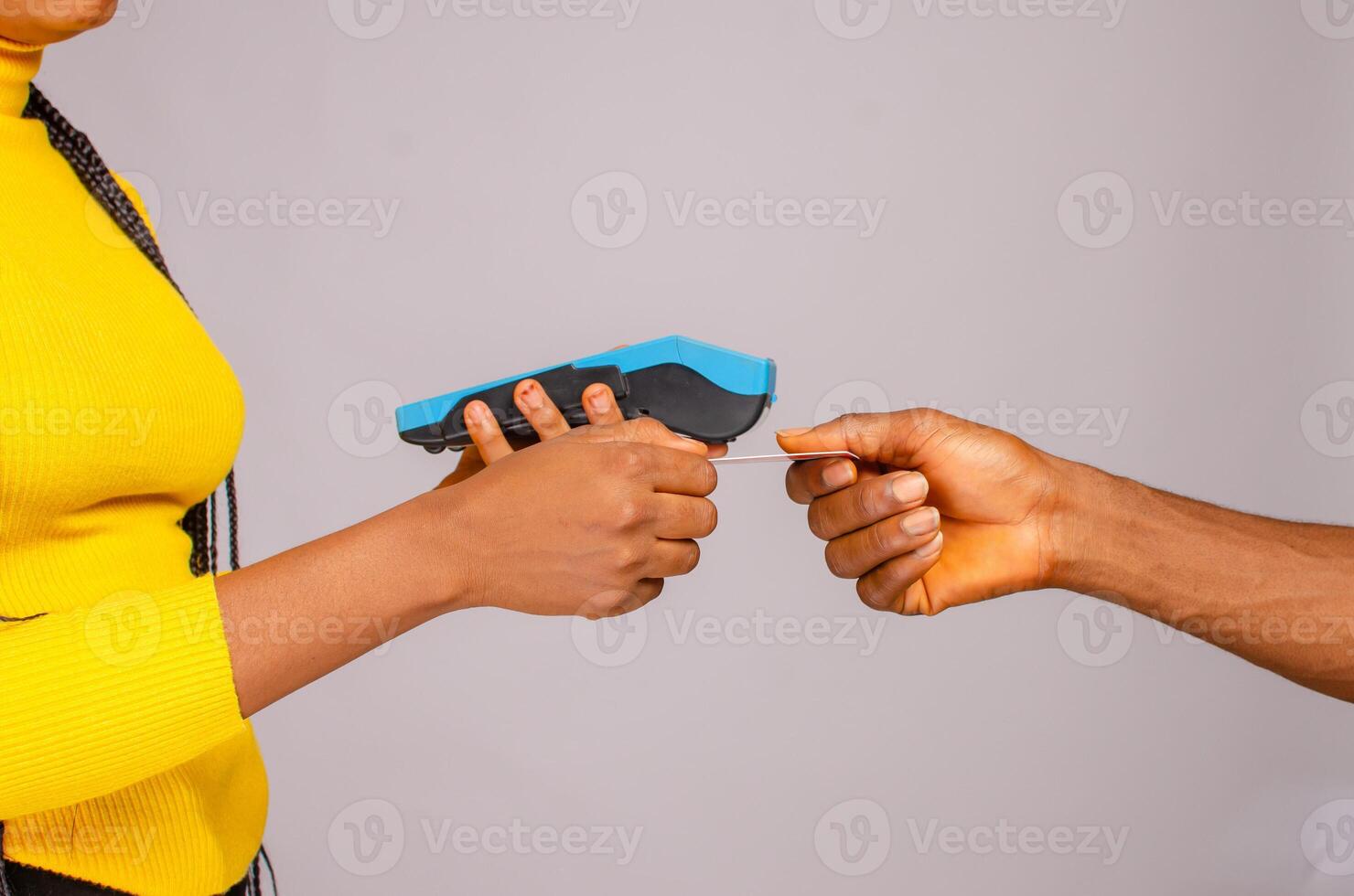Cropped image of customer paying with credit card holding payment terminal photo