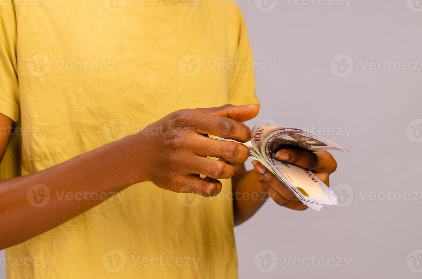close-up of the hand of a african sales boy counting cash naira photo