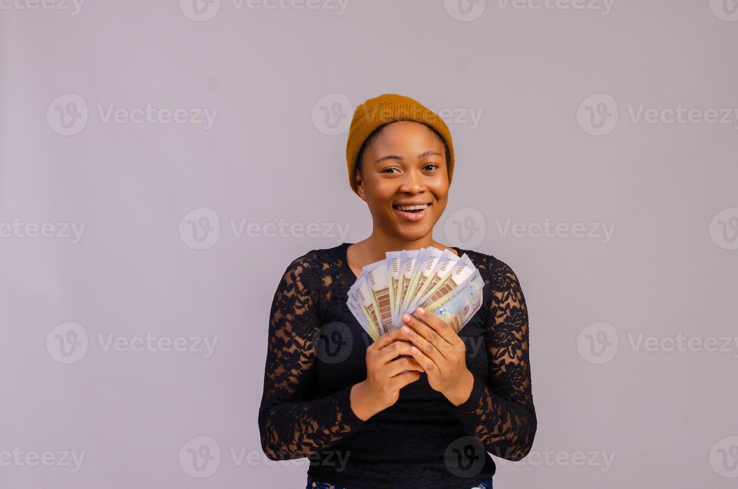 beautiful lady smiling as she holds money on her hand photo