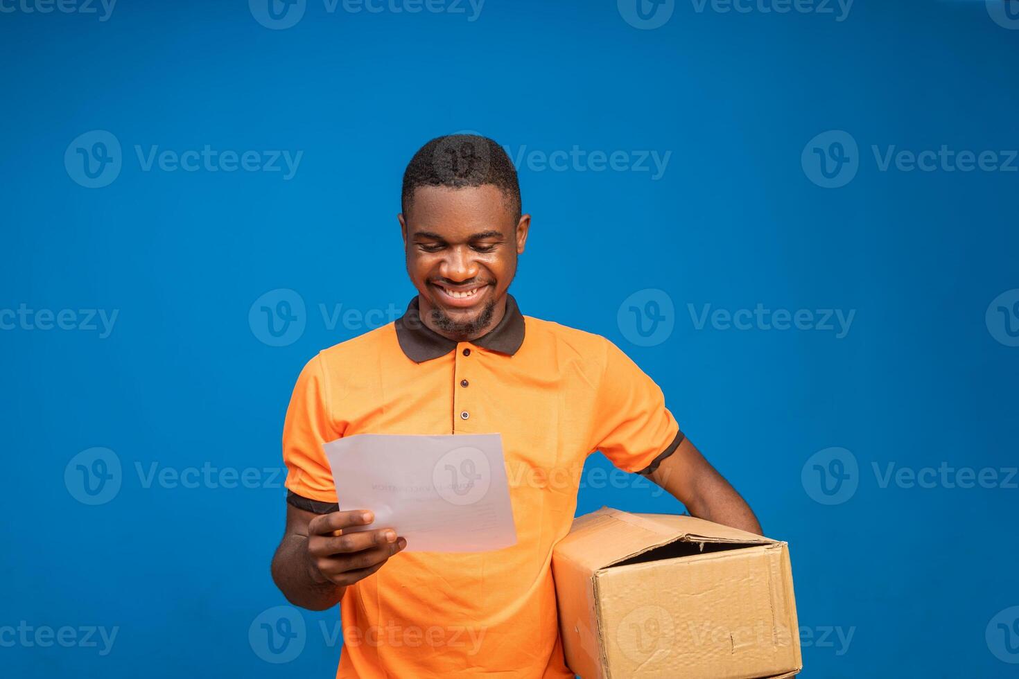 african american delivery man carrying parcel and presenting receiving form photo