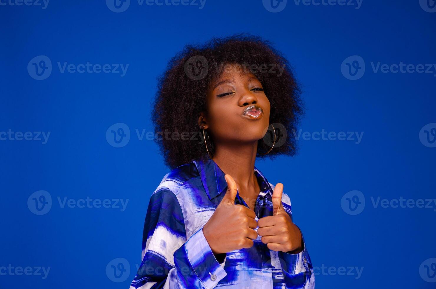 Image of happy young lady standing isolated over blue background. Looking camera pointing photo