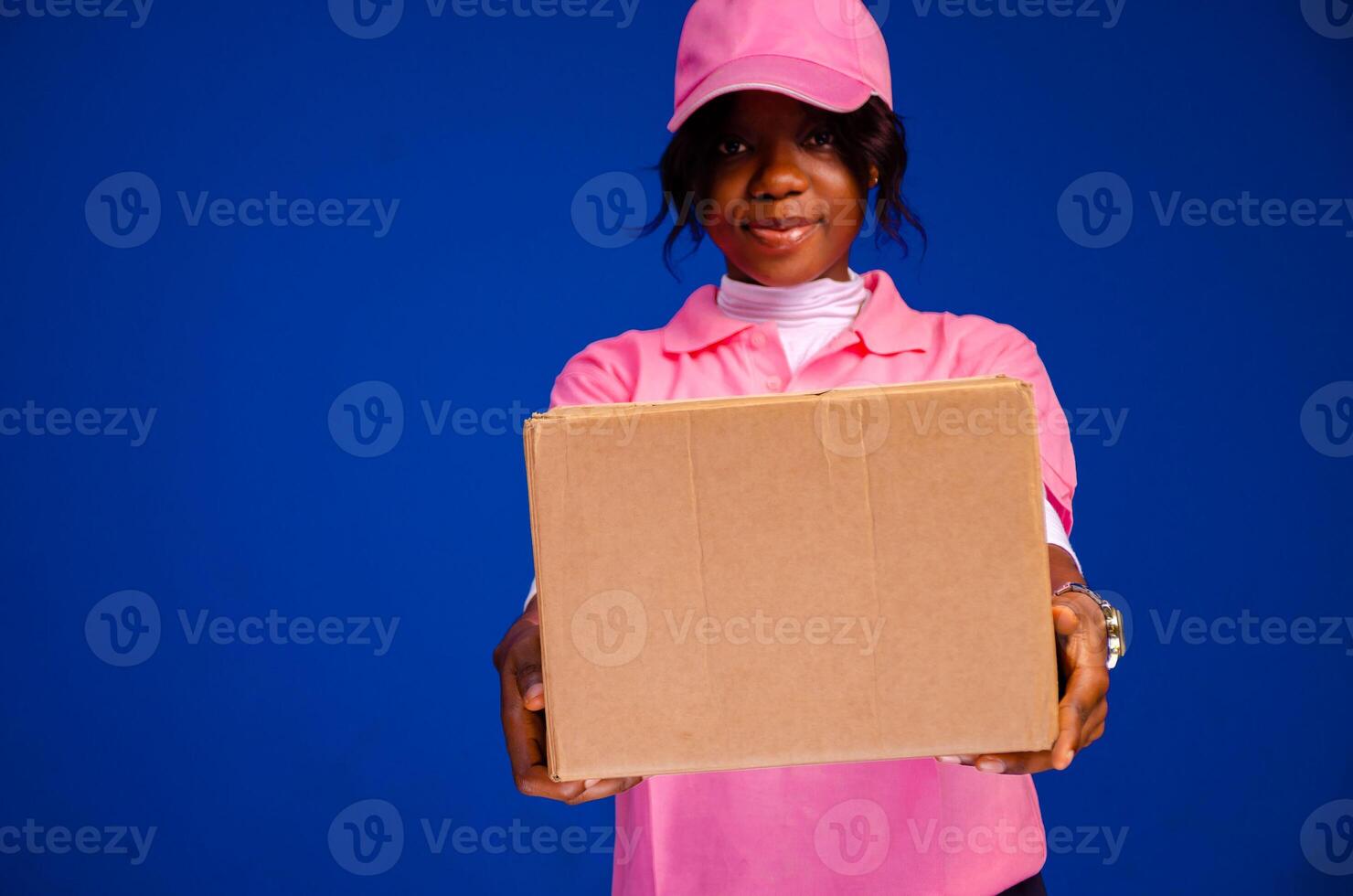 beautiful african delivery woman holding a package photo