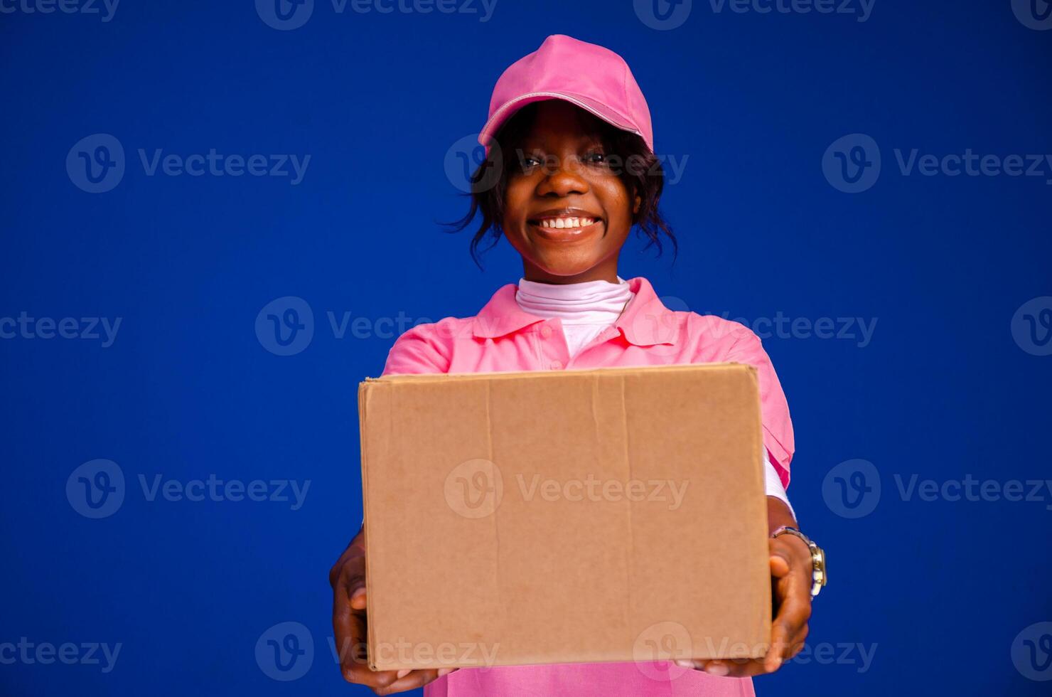 beautiful african delivery woman holding a package photo