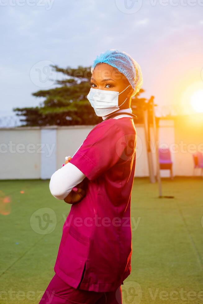 Young black female healthcare worker smiling outside, portrait photo