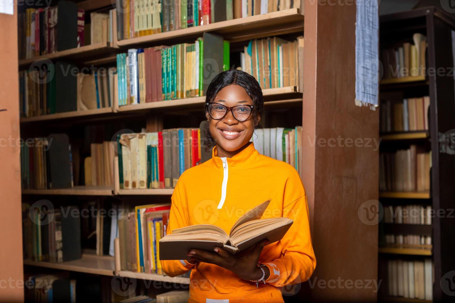 young lady campus student in the library reading. photo