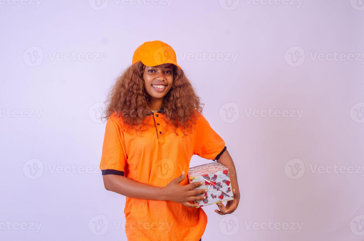 beautiful african female courier worker holding a box photo