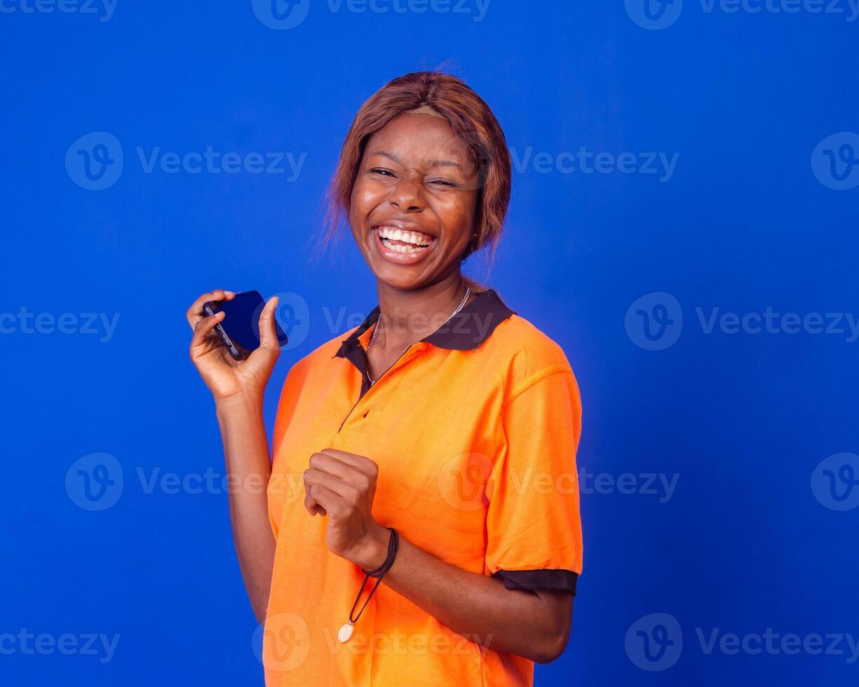 beautiful black girl shows her phone screen while feeling happy and excited, advertising concept, focus on her phone screen photo