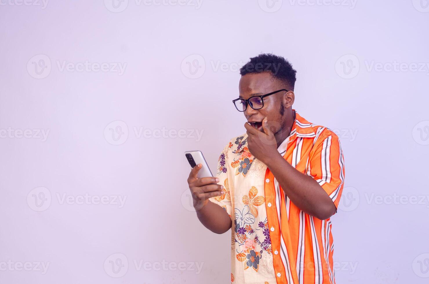 Cheerful African American man in white shirt using mobile phone application. photo