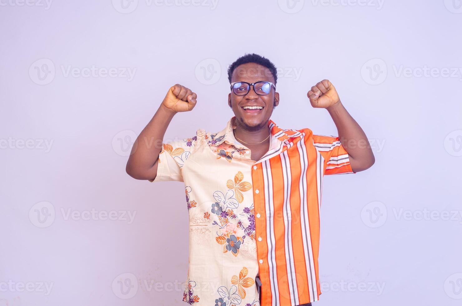 It's incredible Portrait of a happy and excited man looking up with mouth open and both arms up photo
