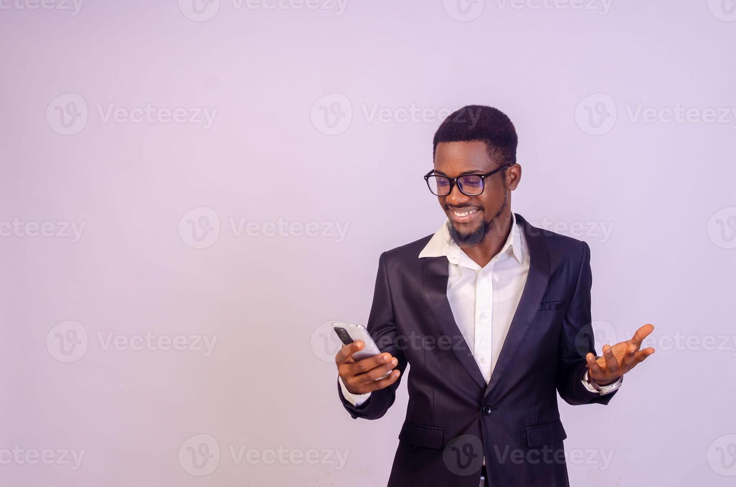 Smiling businessman looking at mobile phone smiling photo