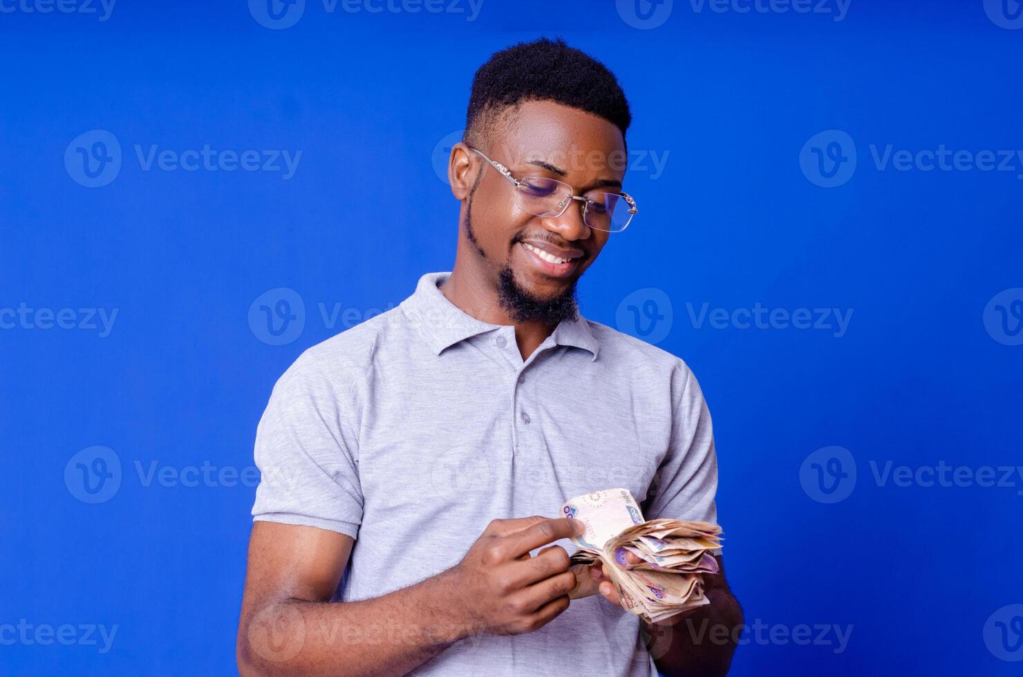 Successful business man counting money and smiling, photo