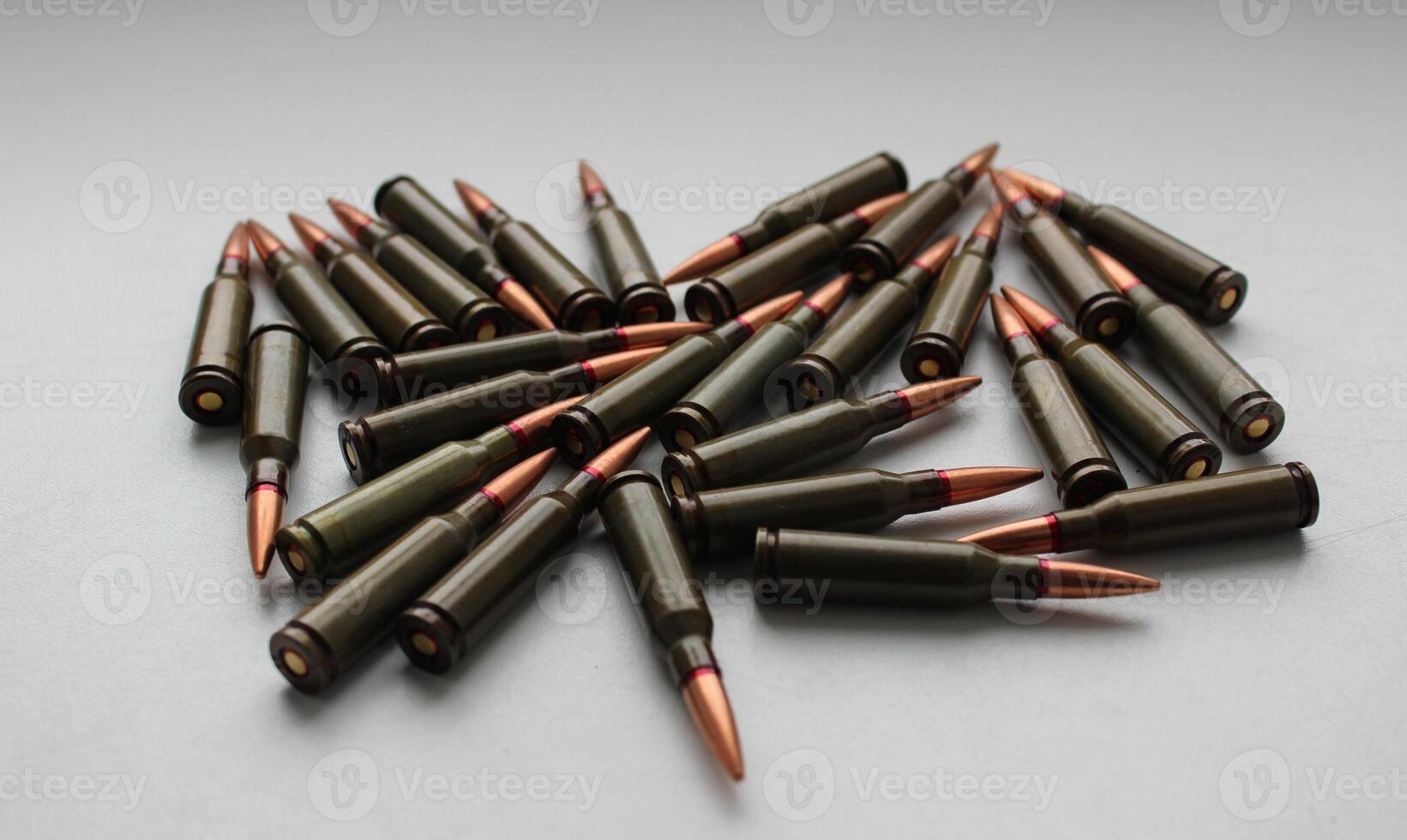 Live ammunition for assault rifle with red mark on a bullets studio isolated angle view photo