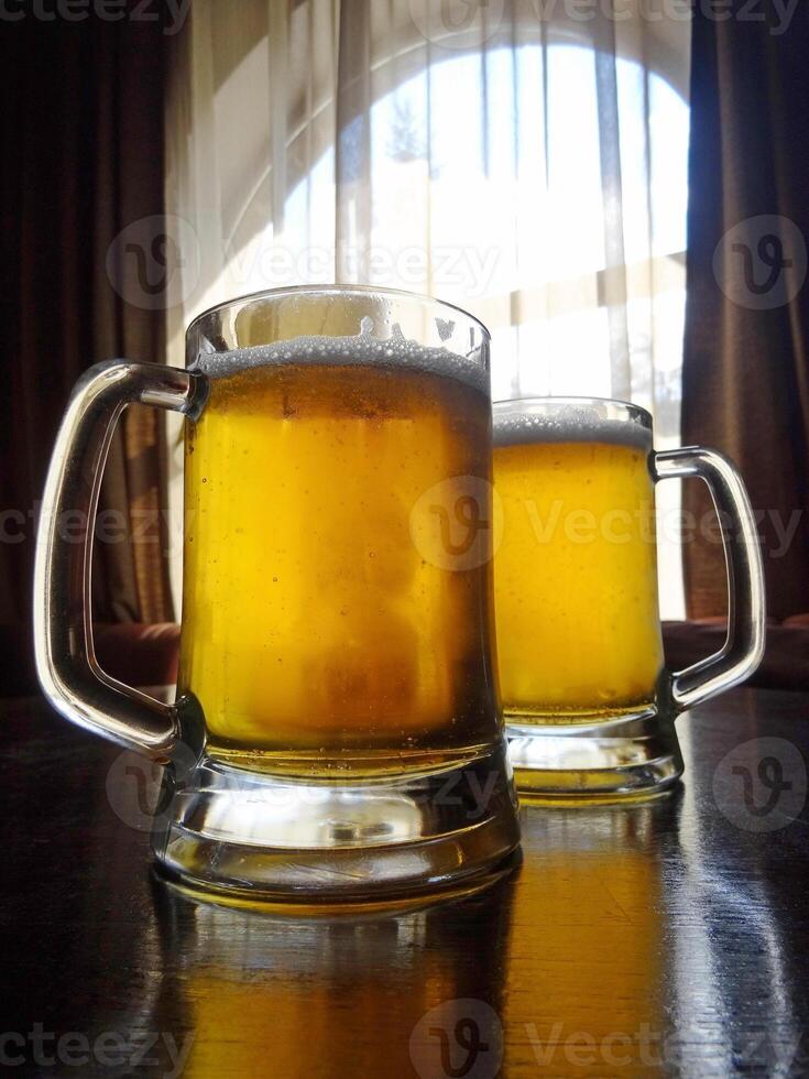 Two craft beer pints on the table detailed stock photo