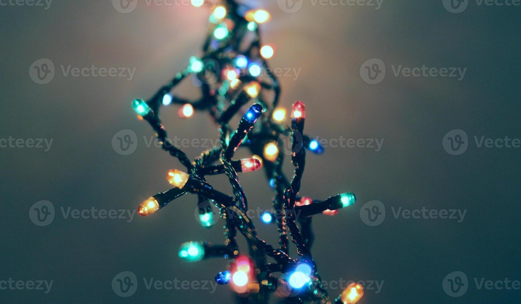 Glares Of A Ceiling From Illuminated Garland With Small Colorful Lamps photo