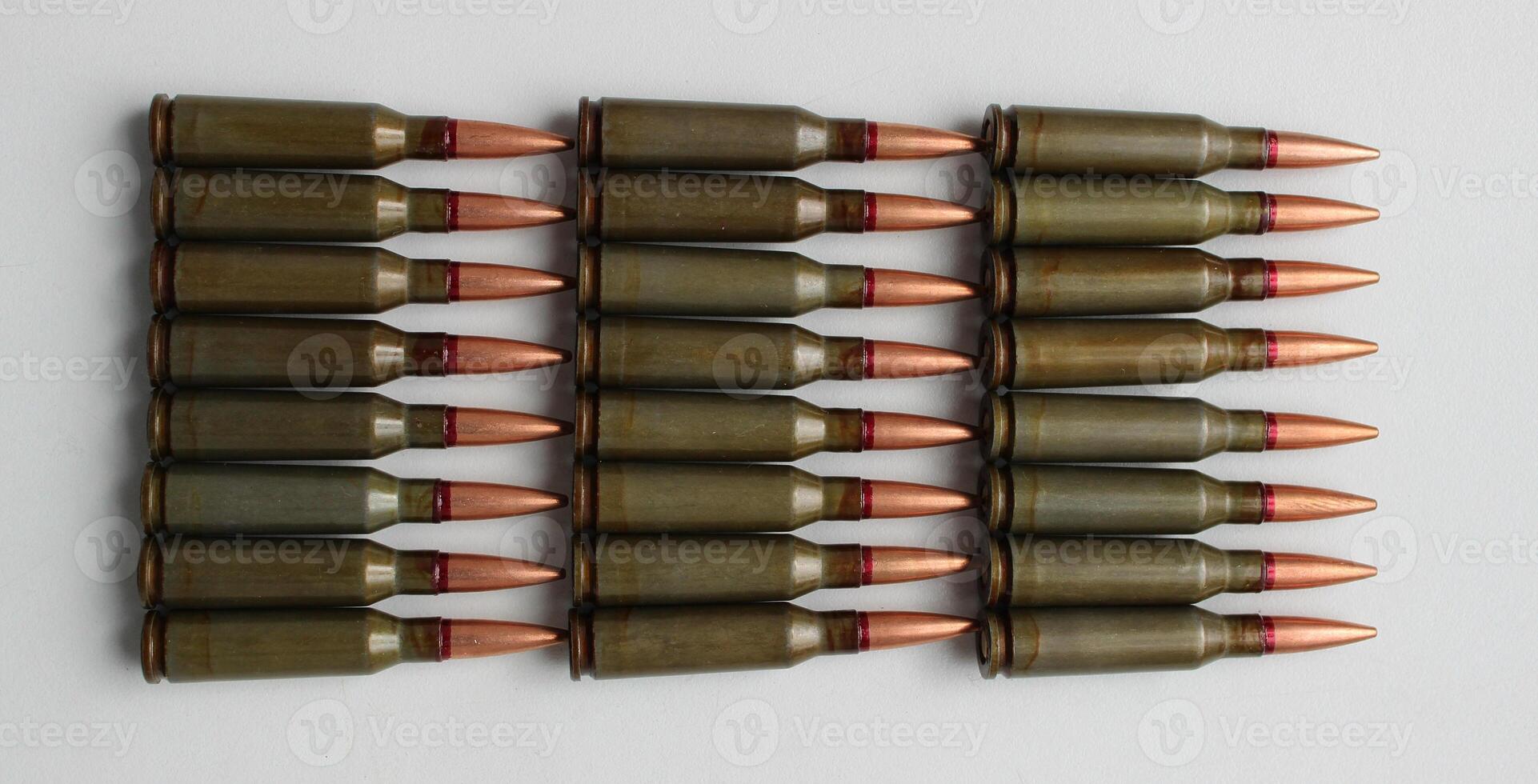 Ammunition for automatic rifle lined up with groups on a white background stock photo