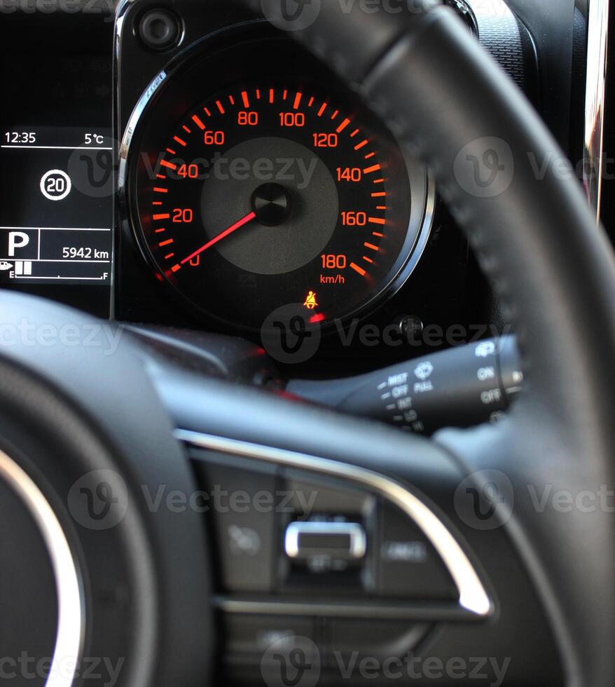 Pictogram of an unfastened seat belt before driving on the car dashboard photo