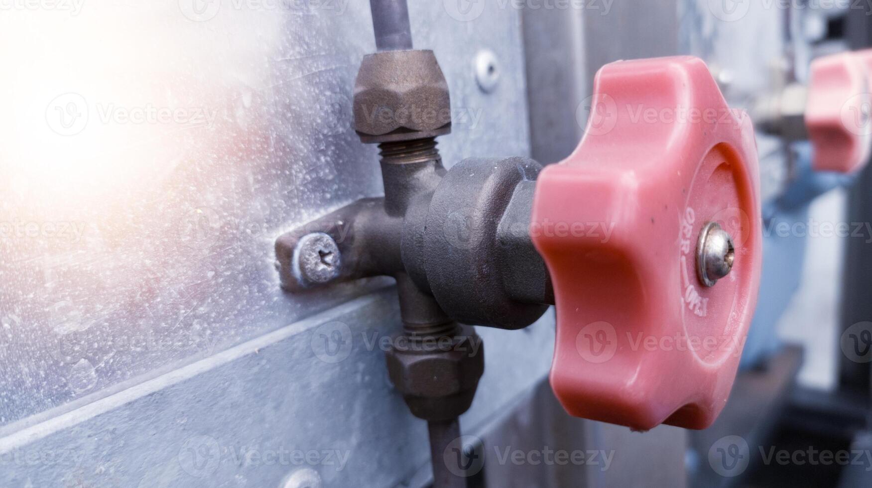 A Cut off valve gate opened or closed at will manually for preventing or regulating flow of a liquid in a refrigerant  pipe. photo