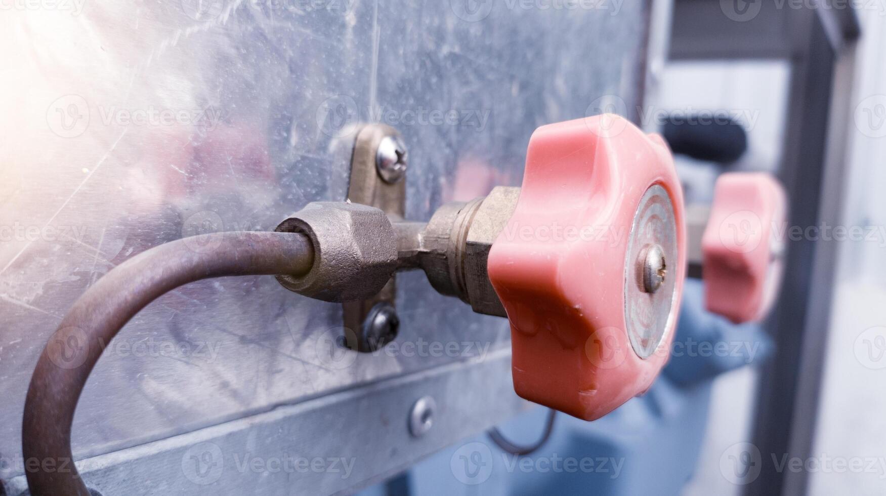 A Cut off valve gate opened or closed at will manually for preventing or regulating flow of a liquid in a refrigerant  pipe. photo